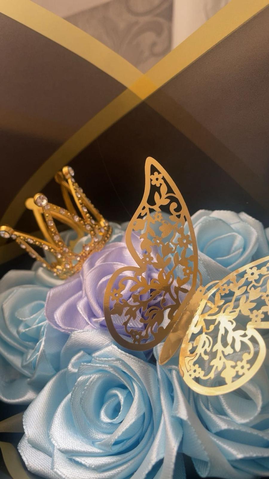 Close-up of handcrafted rose petals and butterfly details